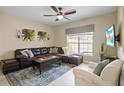 L-shaped sectional sofa, large window and a ceiling fan at 8955 Coco Palm Rd, Kissimmee, FL 34747