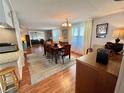 Inviting dining room boasting hardwood floors, seating for eight, seamlessly connecting to living spaces for easy entertaining at 106 Gardenia Way, Leesburg, FL 34748