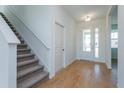 Bright entryway with tile flooring, staircase, and interior door at 1304 Silo Dr, St Cloud, FL 34771