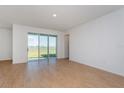 Living room with sliding glass doors and lake view at 1304 Silo Dr, St Cloud, FL 34771