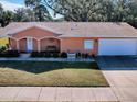 Single-story house with attached garage and neat landscaping at 1415 Park Ave, Tavares, FL 32778