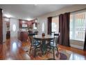 Eat-in kitchen with hardwood floors, granite counters, and dark wood cabinets at 1415 Park Ave, Tavares, FL 32778