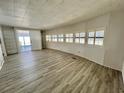 Bright living room featuring modern gray flooring, white walls, and lots of natural light at 149 Royal Palm Dr, Leesburg, FL 34748