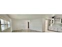 Open living area with modern flooring and ample cabinet space, perfect for entertaining at 149 Royal Palm Dr, Leesburg, FL 34748