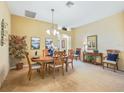 Formal dining room featuring a chandelier, elegant furnishings, and soft natural light at 16814 Se 80Th Bellavista Cir, The Villages, FL 32162