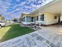 Well-manicured lawn and landscaping enhance the appeal of this home's exterior featuring a comfortable sunroom at 188 Hibiscus Way, Leesburg, FL 34748