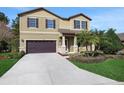 Two-story house with a large driveway and landscaping at 30138 Losino Cv, Mount Dora, FL 32757