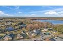 A peaceful community aerial view showcasing a serene lake and lush green surroundings at 3463 Creek Run Ln, Eustis, FL 32736