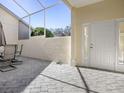 Private patio with pavers, screened enclosure, and seating area at 409 Glen Arbor Ln, Leesburg, FL 34748