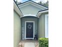 Inviting front door entrance with a decorative wreath and welcome sign at 4813 Waters Gate Dr, Tavares, FL 32778