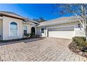 Two-car garage with paver driveway at 5312 Meadow Hill Loop, Lady Lake, FL 32159