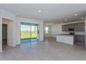 Open concept kitchen with island, gray cabinets, stainless steel appliances and view of backyard at 5792 Timber Meadow Way, St Cloud, FL 34771
