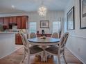 Cozy dining room featuring a chandelier, artwork, and a round table with four chairs at 5812 Ansley Way, Mount Dora, FL 32757