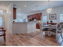 Open concept dining area with hardwood floors and kitchen view at 5812 Ansley Way, Mount Dora, FL 32757
