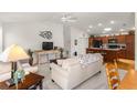 Open living room and kitchen with neutral colors and comfortable furniture at 5867 Marsh Ct, The Villages, FL 32163
