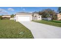 New construction home with a large driveway and grassy yard at 610 Messina Way, Kissimmee, FL 34758