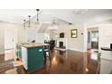 Spacious kitchen with island, hardwood floors, and stained glass window at 7206 Earlwood Ave, Mount Dora, FL 32757