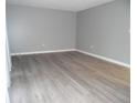 Open living area featuring gray walls and modern, wood-look floors at 723 Perkins St # 104, Leesburg, FL 34748