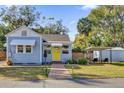 Charming single-story home with a cheerful yellow front door, brick pathway, and lush green lawn at 805 Hackett Ct, Mount Dora, FL 32757