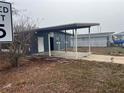 Gray house with carport and mature trees at 1121 Oakland Dr, Tavares, FL 32778