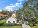 Beautiful lakefront home with spacious driveway and lush landscaping at 11644 Osprey Pointe Blvd, Clermont, FL 34711