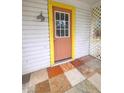 Inviting front door with a yellow frame and terracotta door at 1420 Old Mount Dora Rd, Eustis, FL 32726