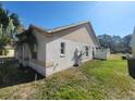 Home's side view, showcasing a grassy yard at 16154 Magnolia Hill St, Clermont, FL 34714