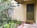 Front entrance with a green door and small garden at 1803 Ne 29Th Pl, Ocala, FL 34479