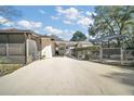 Long driveway leading to a screened enclosure, carport and fenced-in area of the property at 24450 Ne 127Th St, Salt Springs, FL 32134