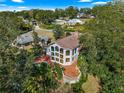 House with a large deck and beautiful landscaping, aerial view at 2450 Topping Pl, Eustis, FL 32726