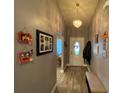 Bright entryway with hardwood floors, bench seating, and Gathering photos at 2613 Crest Dr, Haines City, FL 33844