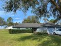 Single-story home with a gray roof, attached garage, and well-maintained lawn at 2613 Crest Dr, Haines City, FL 33844