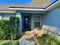 Charming front porch with decorative welcome sign and lush greenery at 2613 Crest Dr, Haines City, FL 33844