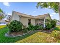 Charming home exterior with a well-manicured lawn and lush landscaping surrounding the house at 3001 Saint Thomas Ln, The Villages, FL 32162