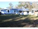 Rear view of a mobile home showing a large backyard at 31735 S Lake Dr, Eustis, FL 32736