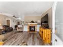 Living room with fireplace and wood flooring at 37610 Quail Ridge Cir, Leesburg, FL 34788