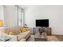 Living Room featuring a neutral couch and wooden coffee table at 3818 Zentko St, The Villages, FL 32163