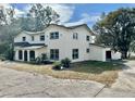 Two-story house showcasing its side profile, white exterior, and landscaping at 4520 N Hiawassee Rd, Orlando, FL 32818