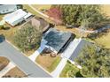 Aerial view of a charming home with well-maintained landscaping, located on a quiet street at 525 Bonita Dr, Lady Lake, FL 32159