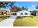 Charming one-story home with a long driveway and carport, located on a well-manicured lawn at 525 Bonita Dr, Lady Lake, FL 32159