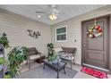 Covered porch with wicker furniture and a welcome mat at 6206 Dingman Way, The Villages, FL 32163