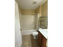 Bathroom with shower over tub, neutral walls, tile floor, and wood vanity at 6340 Oren Ct, Apopka, FL 32712