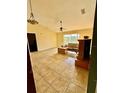 Living room with tile floors, a ceiling fan, and a window that provides natural light at 6340 Oren Ct, Apopka, FL 32712