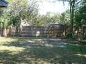 Expansive fenced backyard featuring mature trees and plenty of green space at 703 Sullivan Ave, Ocoee, FL 34761