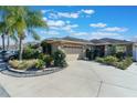 Front view of a single-Gathering home with a two-car garage and manicured landscaping at 7592 Se 170Th Longview Ln, The Villages, FL 32162