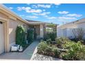 Inviting front entry with walkway, lush landscaping, and charming decor at 7592 Se 170Th Longview Ln, The Villages, FL 32162