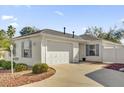 White house exterior with a large garage and driveway at 814 Hilda Way, The Villages, FL 32162