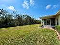 Large backyard with grassy area and screened porch at 917 Shorehaven Dr, Poinciana, FL 34759