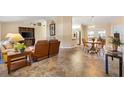 Inviting living room and dining area featuring cozy furnishings and tile flooring at 9184 Se 135Th St, Summerfield, FL 34491