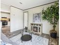 Living room features a fireplace, large windows, and gray couch at 00 Mark Ave, Lady Lake, FL 32159